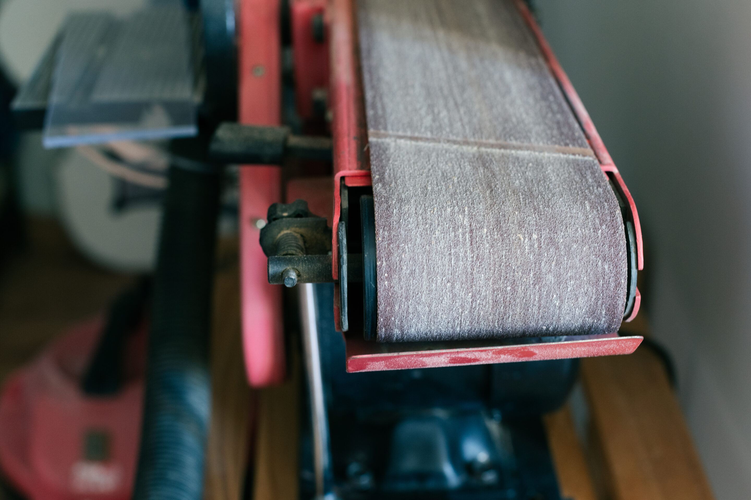 Closeup of a used belt sander in a luthier's workshop